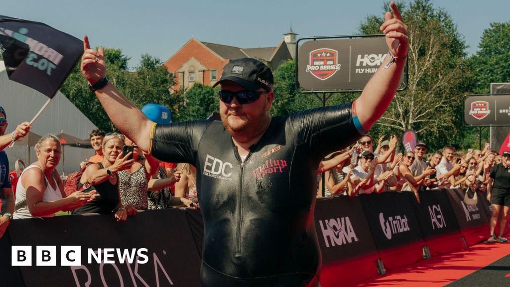 BBCWalesNews's tweet card. A man who weighed over 23 stone and could barely swim completes the Ironman 70.3 triathlon.