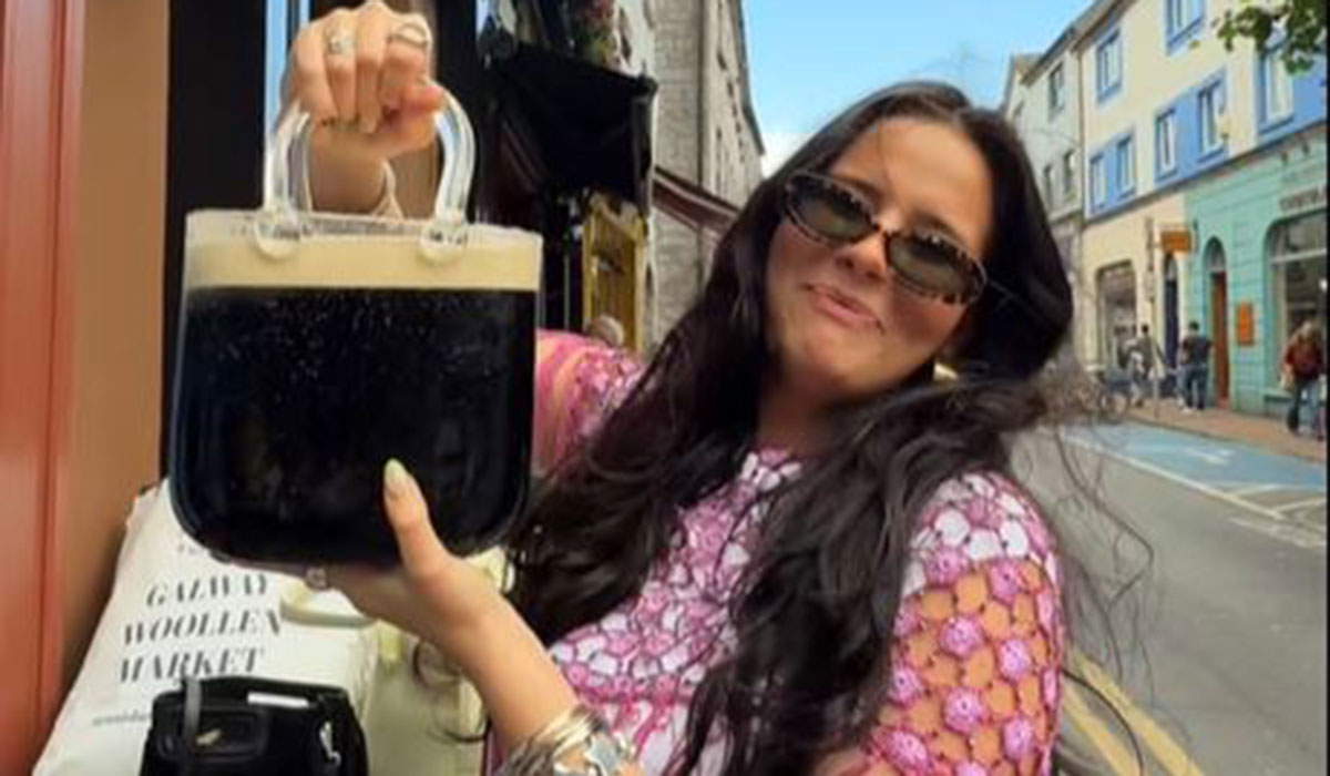 ExtraIRL's tweet card. An American influencer has taken her love for Guinness to the next level — by turning a glass purse into a portable pint glass on the streets of Galway.