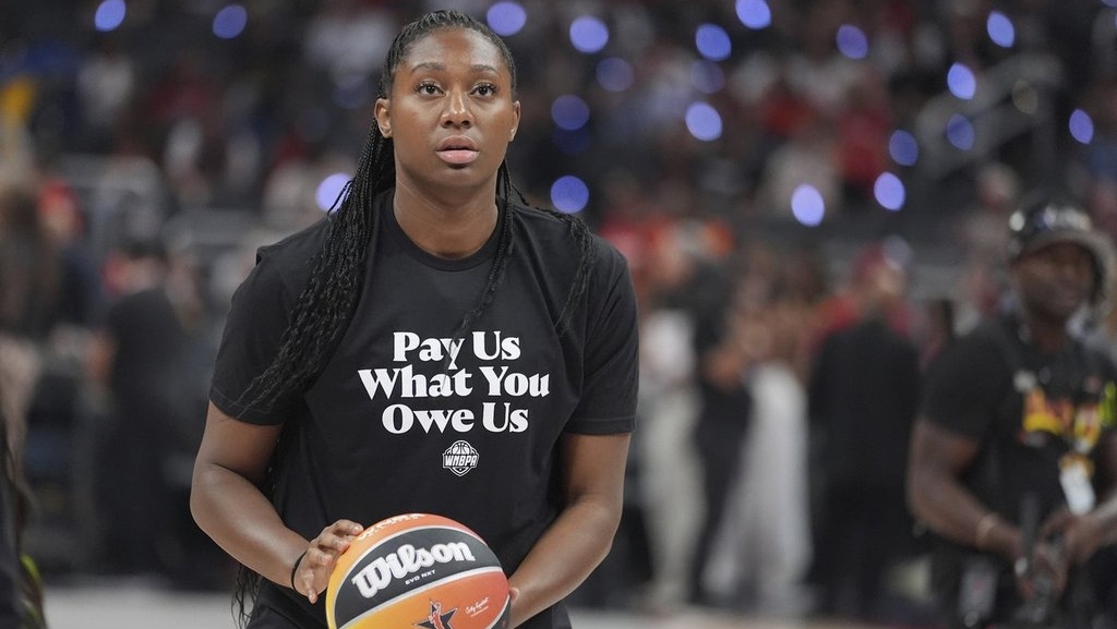 TheLawofWork's tweet card. All of the players on Team Clark and Team Collier warmed up for Saturday night’s WNBA All-Star Game in shirts that read “Pay us what you owe us.”