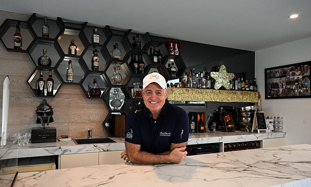 Nik_Simon88's tweet card. David Campese is holding court in the bar at his home on the Gold Coast. On the top floor, we look out across the booming skyline they call Surfer's Paradise.