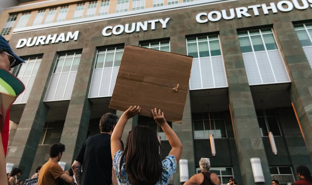 DurhamDispatch's tweet card. Around 100 people gathered at CCB Plaza and the Durham County Courthouse on Wednesday evening after ICE sighted at courthouse