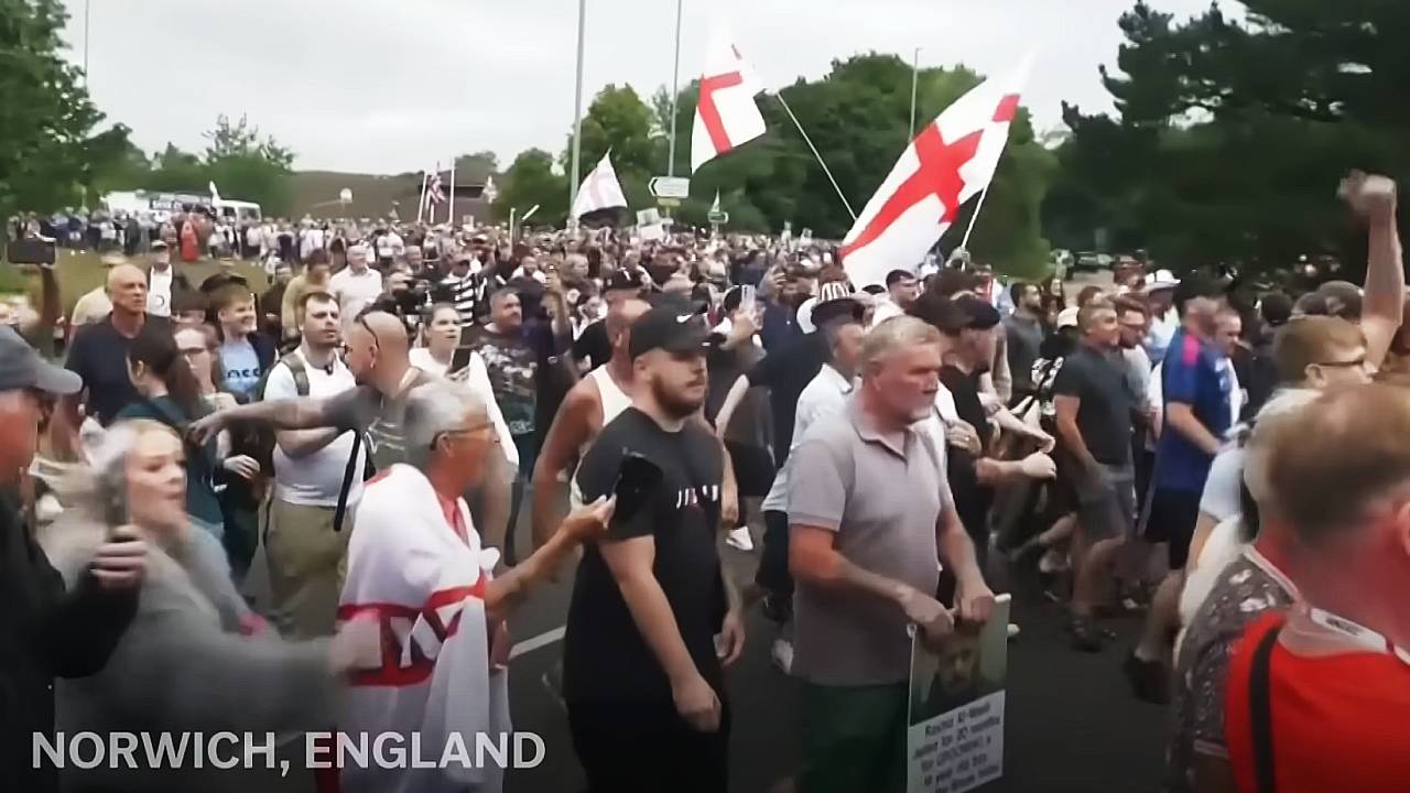 jonminney24's tweet card. And an "elite" police unit is monitoring anti-mass migration social media posts
