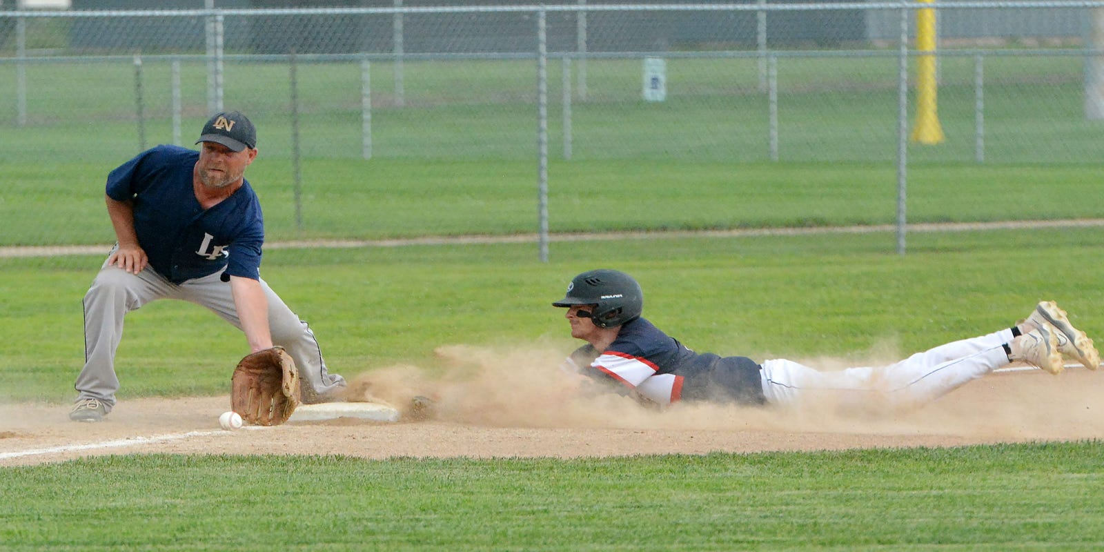 PO_Sports's tweet card. Photos of game in District 1B amateur baseball tournament before rain suspends play.