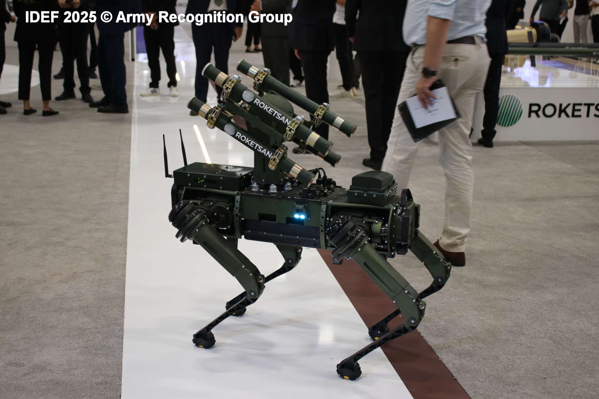 ArmyRecognition's tweet card. Roketsan Presents KOZ Robotic Dog Armed with Missiles at IDEF 2025 to Redefine Battlefield Tactics