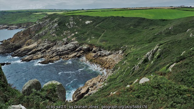 DerekJohnBryant's tweet card. The south west coastal path makes its way around Porthguarnon passing over the small wooden footbridge.