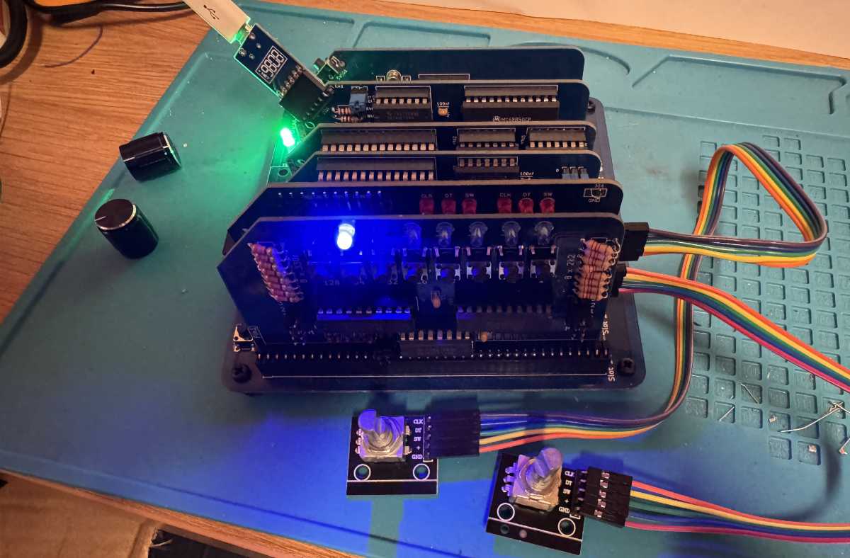 robertprice's tweet card. Reading my rotary encoder module for the RC2014 and using it to move LEDs on a Digital I/O board using Z80 assembly language.