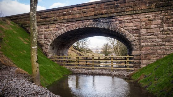 theHREgroup's tweet card. The infilling of the 8.4m single span masonry arch bridge with around 1,000t of concrete was carried out by between May and July 2021 at a cost of