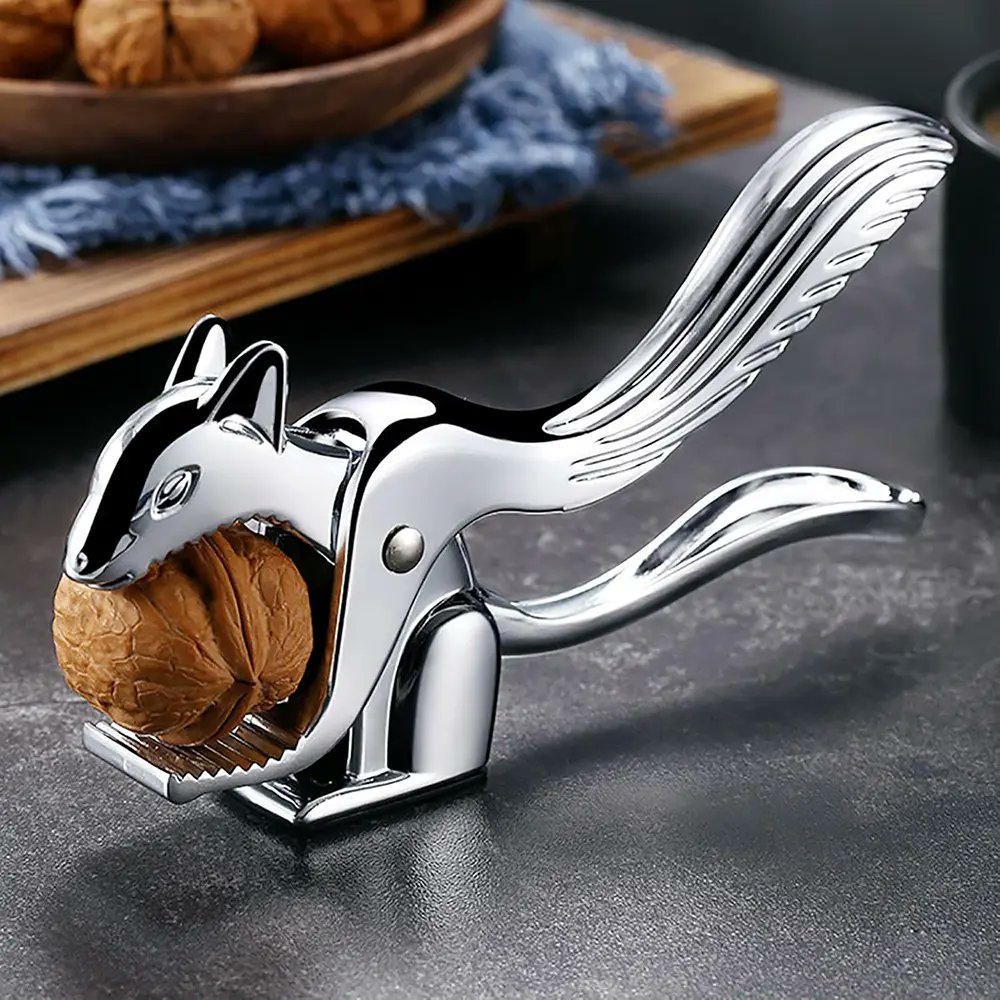 DesignSwan's tweet card. Discover the Squirrel Nutcracker, a durable and fun tool that cracks all types of nuts easily without damaging the delicious nut inside.