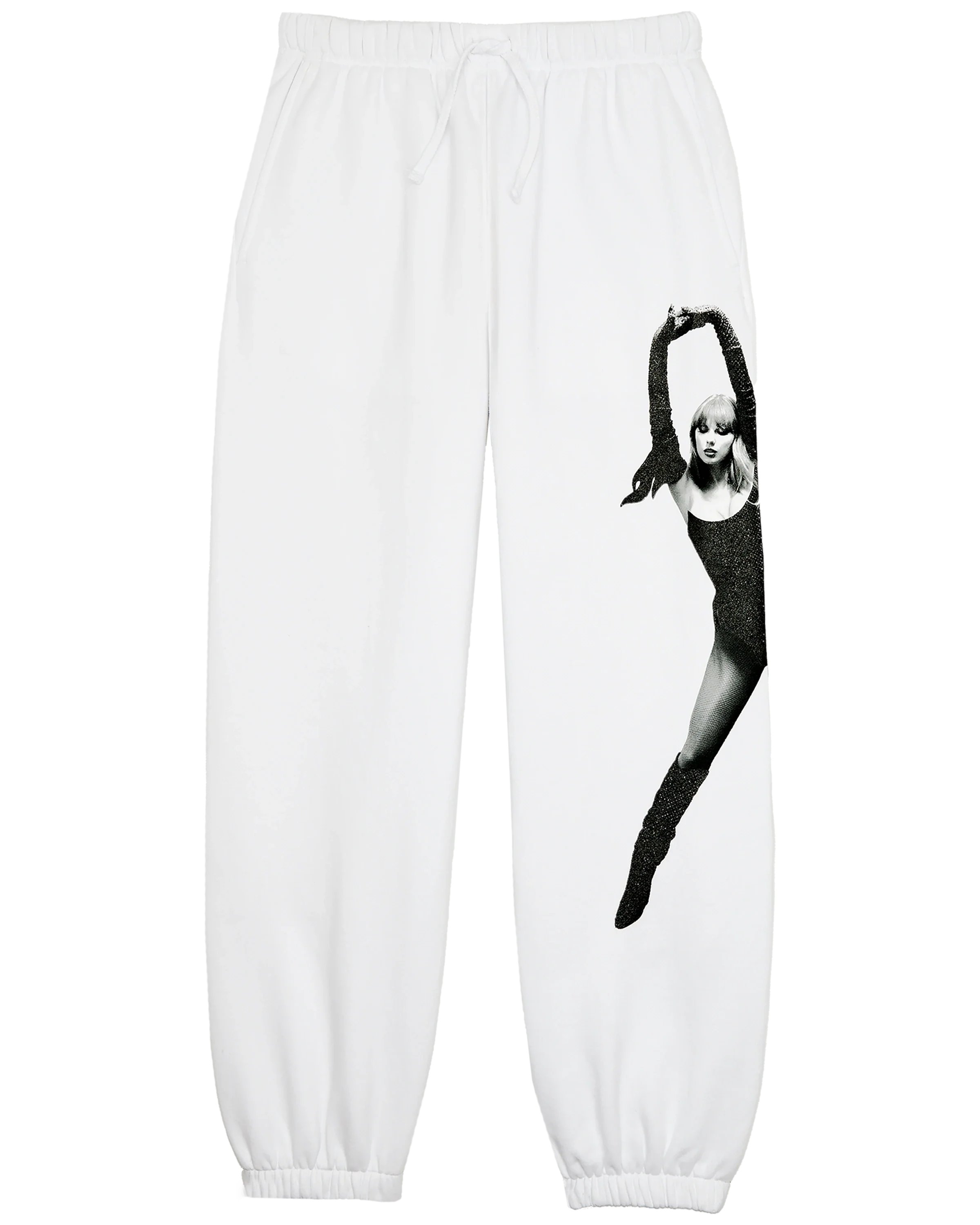 Alerts4Merch_CA's tweet card. WHITE SWEATPANTS FEATURING PHOTO OF TAYLOR SWIFT WITH BLACK SPARKLE OUTFIT ACCENTS PRINTED DOWN WEARER'S LEFT LEG AND "THE LIFE OF A SHOWGIRL" ALBUM LOGO PRINTED DOWN WEARER'S RIGHT LEG.   STANDARD...