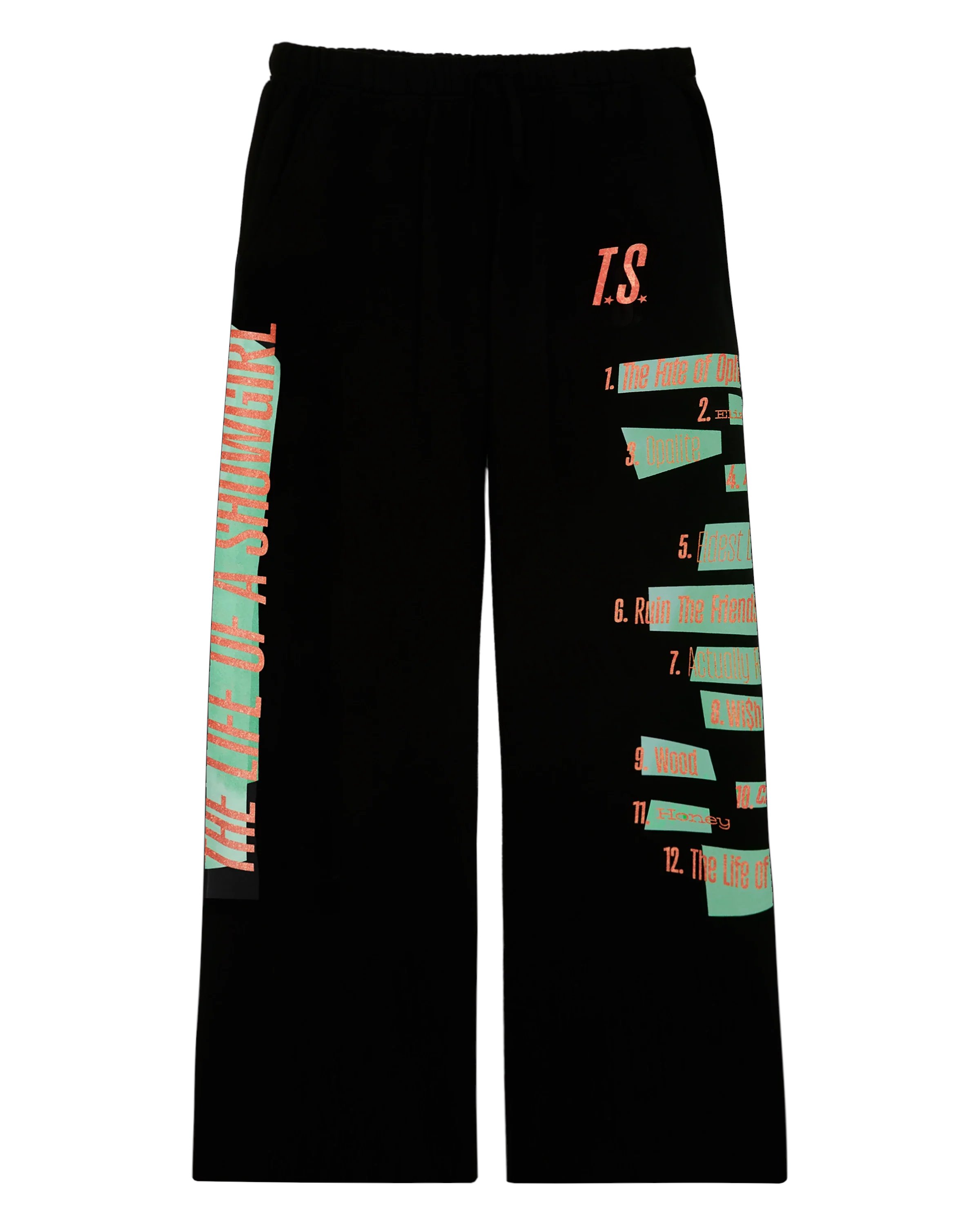 Alerts4Merch_CA's tweet card. BLACK SWEATPANTS WITH BACK POCKET FEATURING "T.S." LOGO IN ORANGE GLITTER PRINT ON WEARER'S LEFT LEG AND TRACKLIST IN ORANGE GLITTER PRINT ON MINT GREEN GRAPHIC DOWN WEARER'S LEFT LEG AND "THE LIFE...