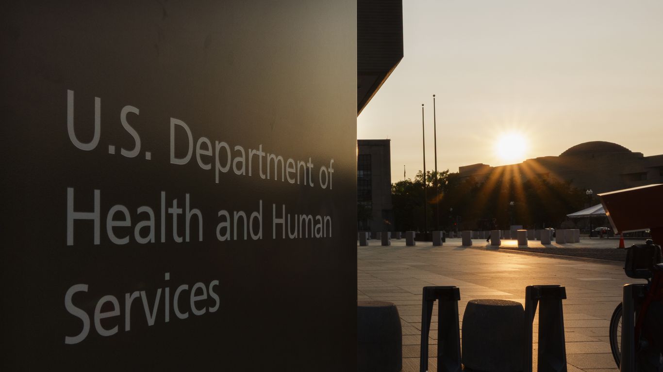 axios's tweet card. An HHS spokesperson says employees "across multiple divisions" have received reduction-in-force notices.