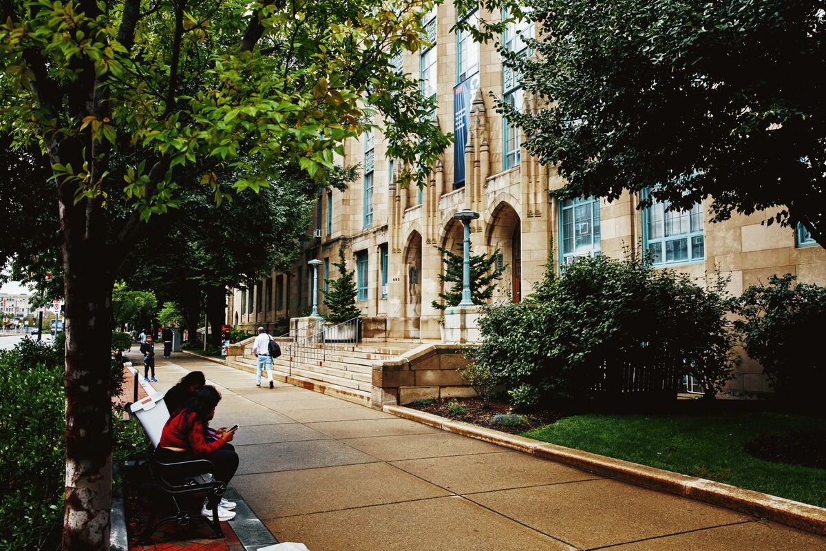 business's tweet card. Boston University is eliminating staff and reducing spending as the school grapples with the Trump administration’s push to reshape higher education and a pullback in research funding.