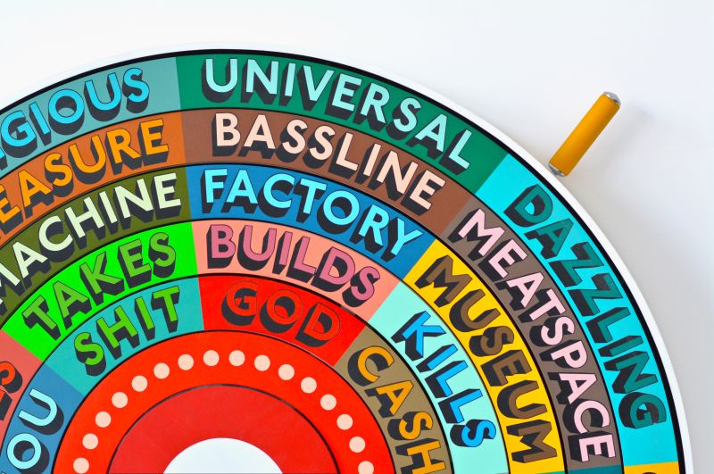 TutorialVideos2's tweet card. A rainbow-coloured wheel of fortune that helps us to make random, dystopian poems.