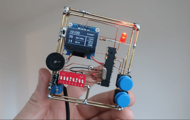 hackaday's tweet card. We sure wish we’d had a teacher like [Danko Bertović]. He built this beautiful circuit sculpture to teach his students how to count in binary and convert it to decimal and hexadecimal. If you…