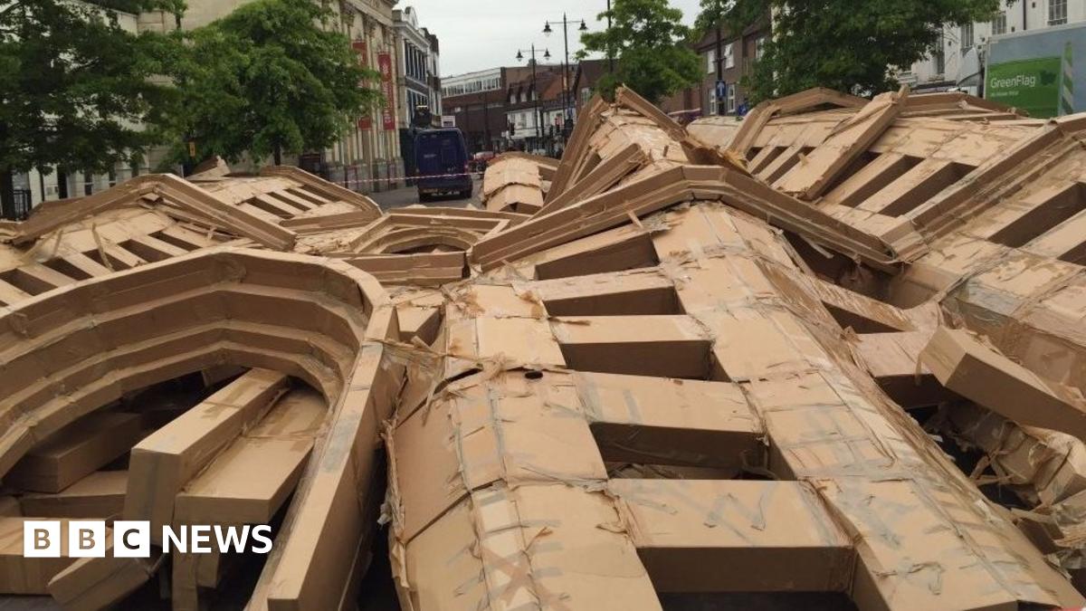 FastPakNet's tweet card. A giant cardboard replica of Donnington Castle was toppled by the wind before it could be dramatically demolished as part of a celebration of the artwork, organisers say.