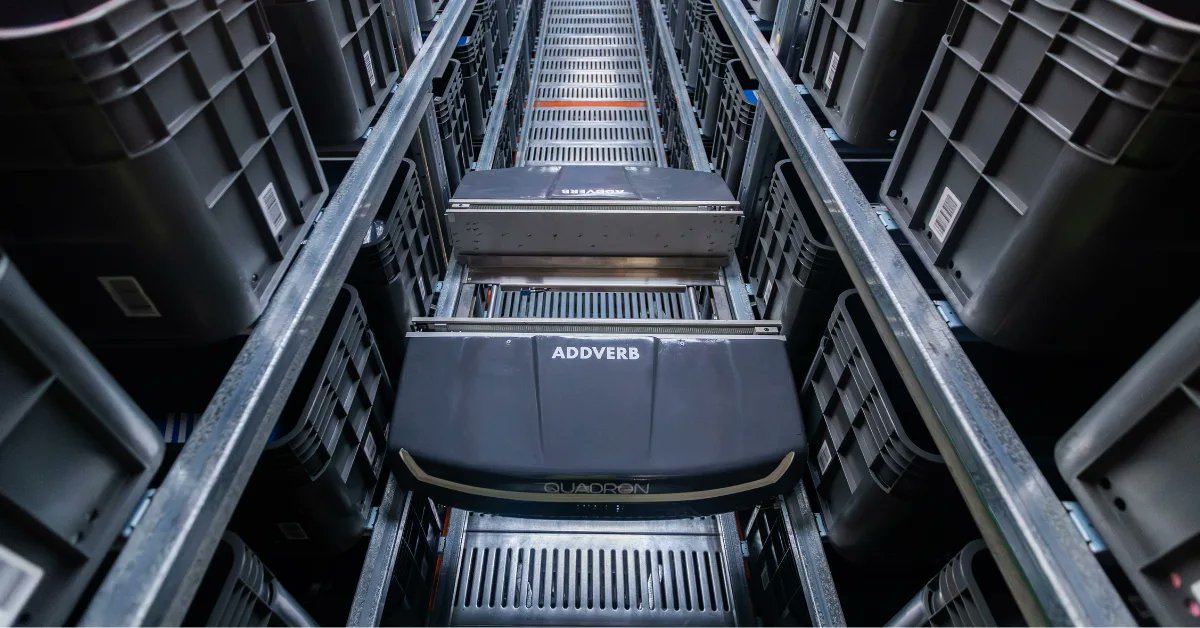 Addverb_Tech's tweet card. Think of aiming to achieve warehouse efficiency with long aisles of racks, workers walking back and forth with trolleys and orders being picked manually. At