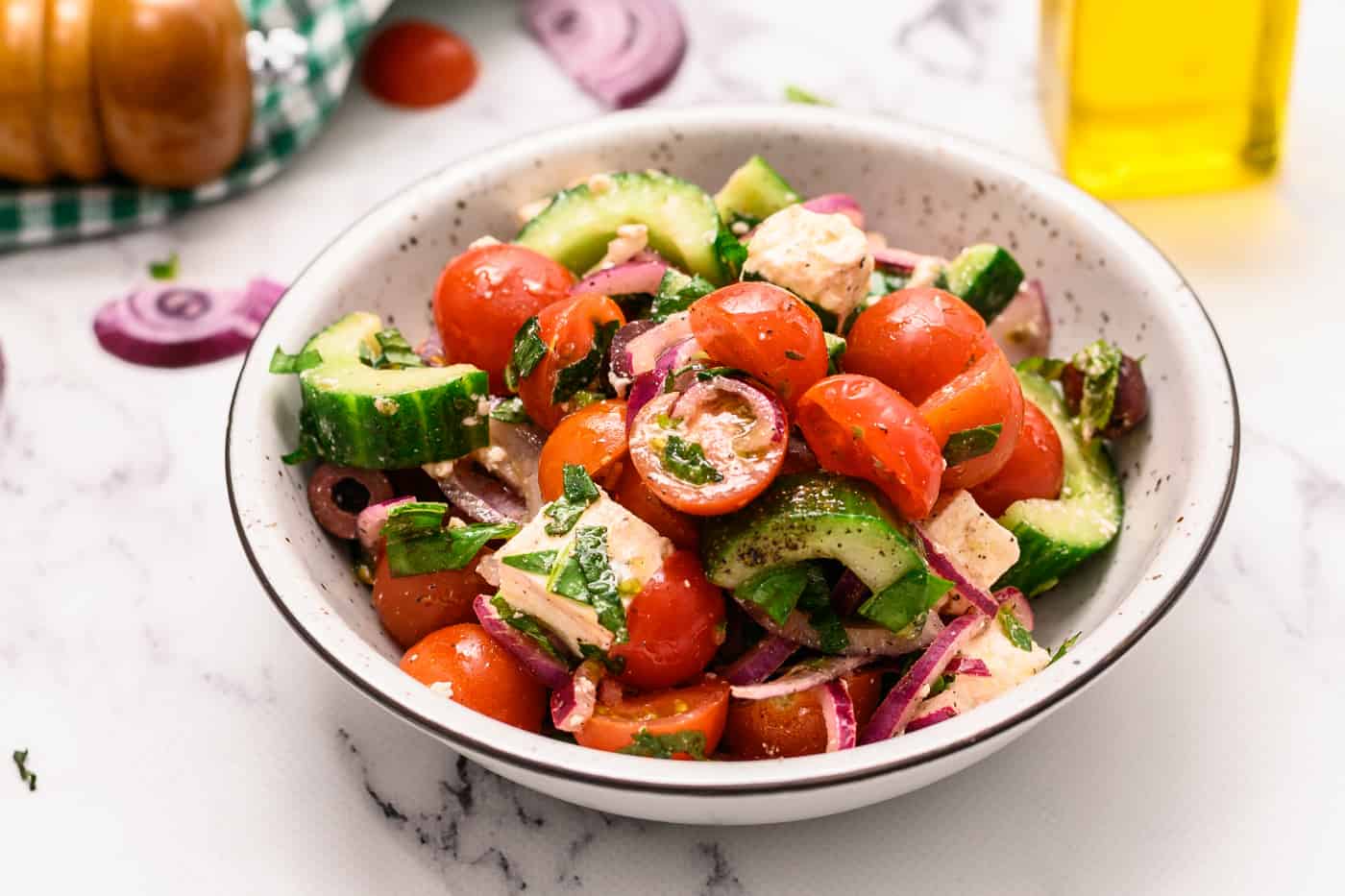 TwistedPurl's tweet card. Greek Peasant Salad is packed with cucumbers, tomatoes, red onion, creamy Feta cheese, Kalamata olives, fresh herbs, and a vinaigrette.