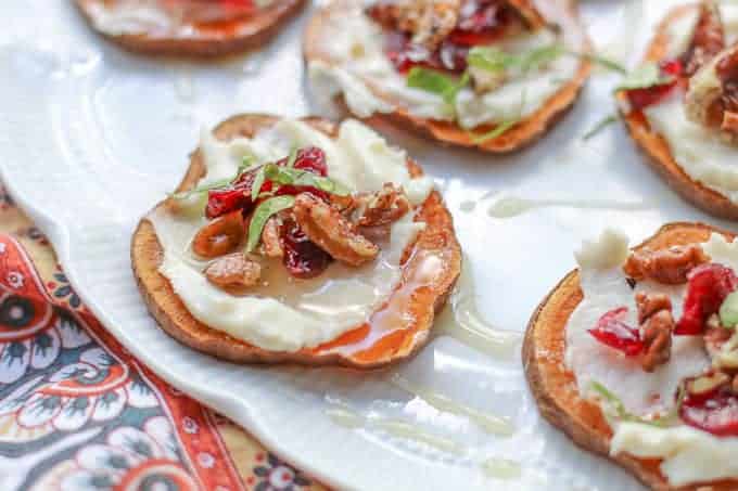 servfromscratch's tweet card. These gluten-free sweet potato bites are topped with creamy whipped goat cheese, tangy dried cranberries, and crunchy pecans.They are finished with a golden drizzle of honey.