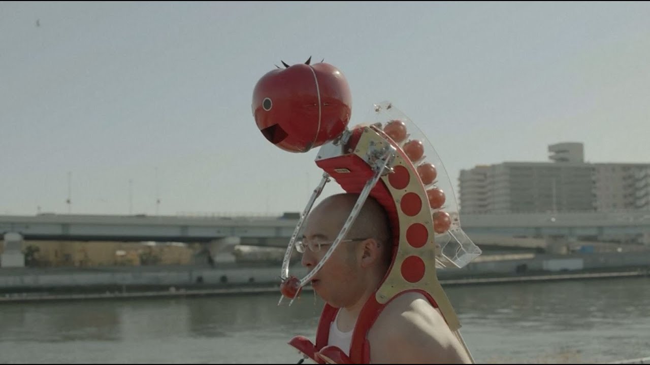 qikipedia's tweet card. Meet Tomatan, a wearable robot that feeds you tomatoes as you run