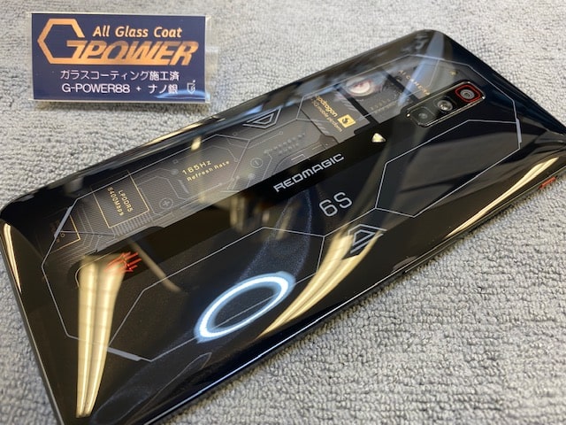 shieldokazaki's tweet card. ゲーミングスマホ「RED MAGIC 6SPRO」をガラスコーティング！ 背面がスケルトンデザインで透明感のあるとてもカッコいいゲーミングスマホをお持ちいただきました！ 6.8インチのディスプレイ面と内部が透けて見えるスケルトンデザインの背面の両面にガラスコーティング（G-POWER88）と、抗菌効果のあるTOPコート「ナノ銀イオンコート」を一施工させていただきました！！ナノレベルのガラスコ...