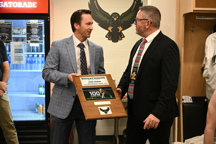 AdamLeviLAX's tweet card. Dan Carey (left) presents Mike Hasen with a plaque in honour of Hasen's 100th NLL head coaching win. (Photo: Micheline Veluvolu/NLL)Mike