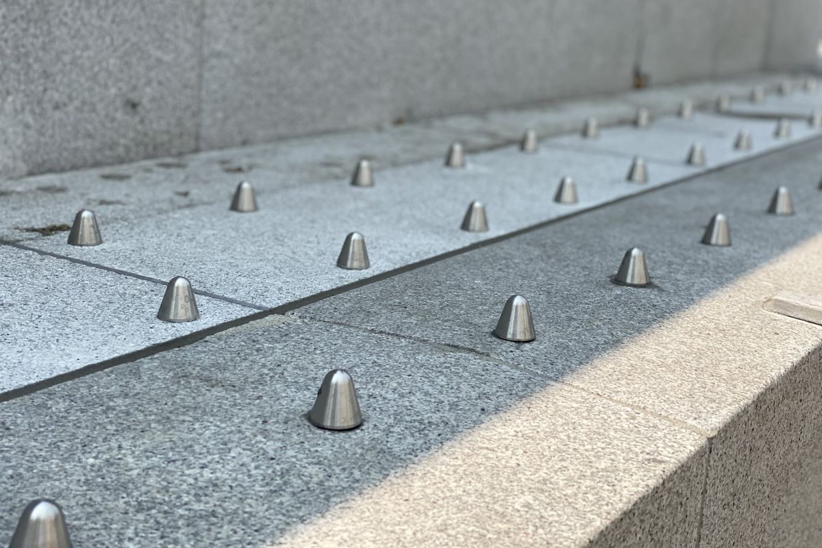 homeless_new's tweet card. Hostile architecture is inhumane. Homeless people have no place to sit, stand, or lie comfortably. This is not an accident. It’s a modern design.