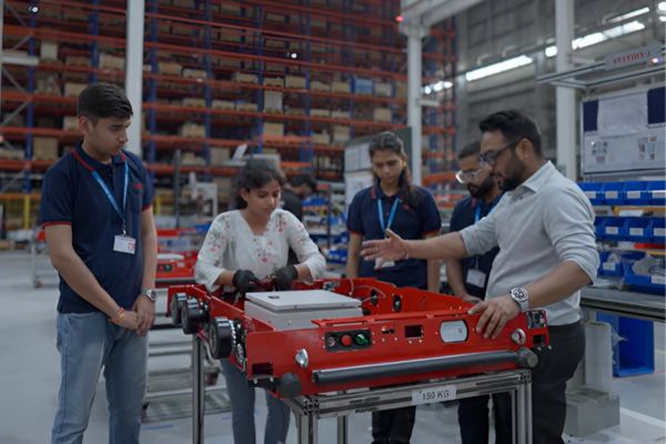 TimestechBuzz's tweet card. Addverb,, a global leader in robotics and automation, is partnering with leading institutions such as IIT’s, NAMTECH, Robotics Innovation.