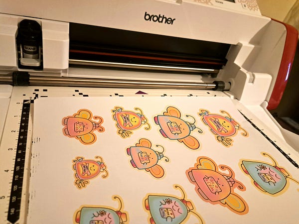 Niguanta's tweet card. I finally chose a sticker cutter machine: the Brother ScanNCut! There were other famous brands promoted out there, the Cricut Maker and the…