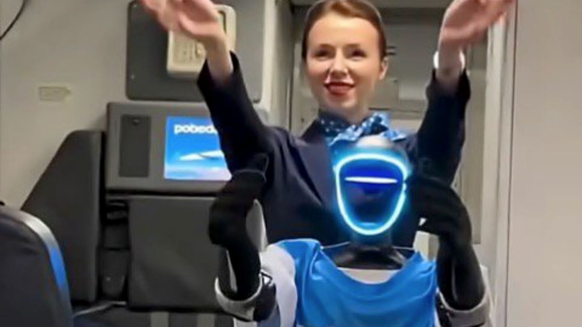 iva_hadenuff's tweet card. THIS is the moment a humanoid robot air steward greets passengers on board a packed flight in Russia in an eerie world first. The machine, named Volodya, welcomes passengers on board the flight and…