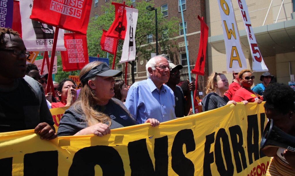 BernieSanders's tweet card. Photo from Bernie Sanders in a march with striking McDonald's workers in Cedar Rapids three weeks ago.
