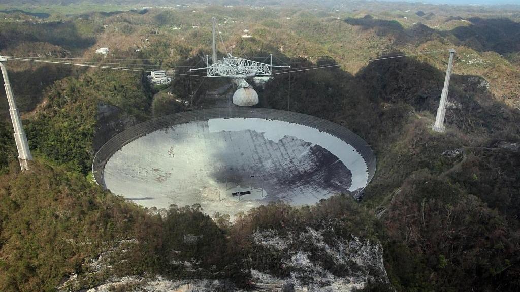 jimwyss's tweet card. The Arecibo Observatory, a massive radio telescope nestled in the mountains of central Puerto Rico that was built in 1963 and has been featured in films, was struck by the eye of the hurricane but...