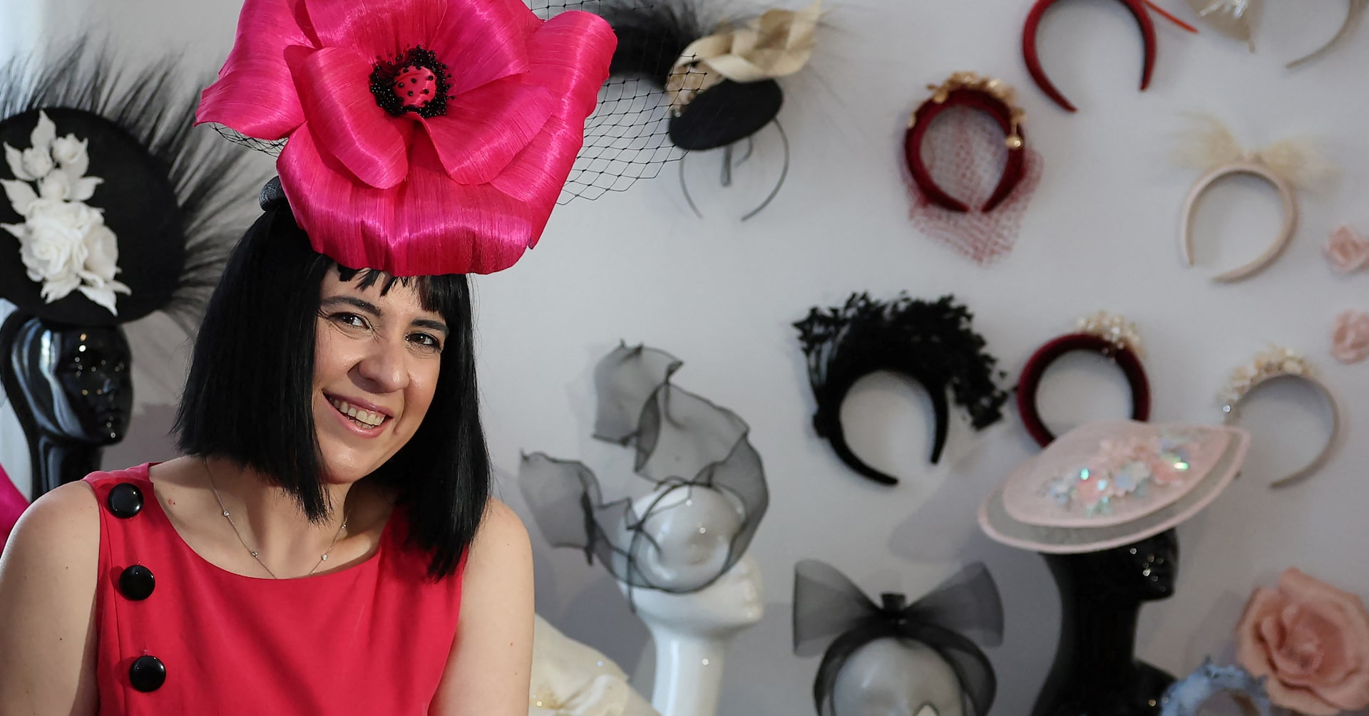 turc35's tweet card. At her London studio, Merve Bayindir carefully glues on dried flowers onto a pale pink saucer hat. Nearby, an array of other colourful headpieces are on display.
