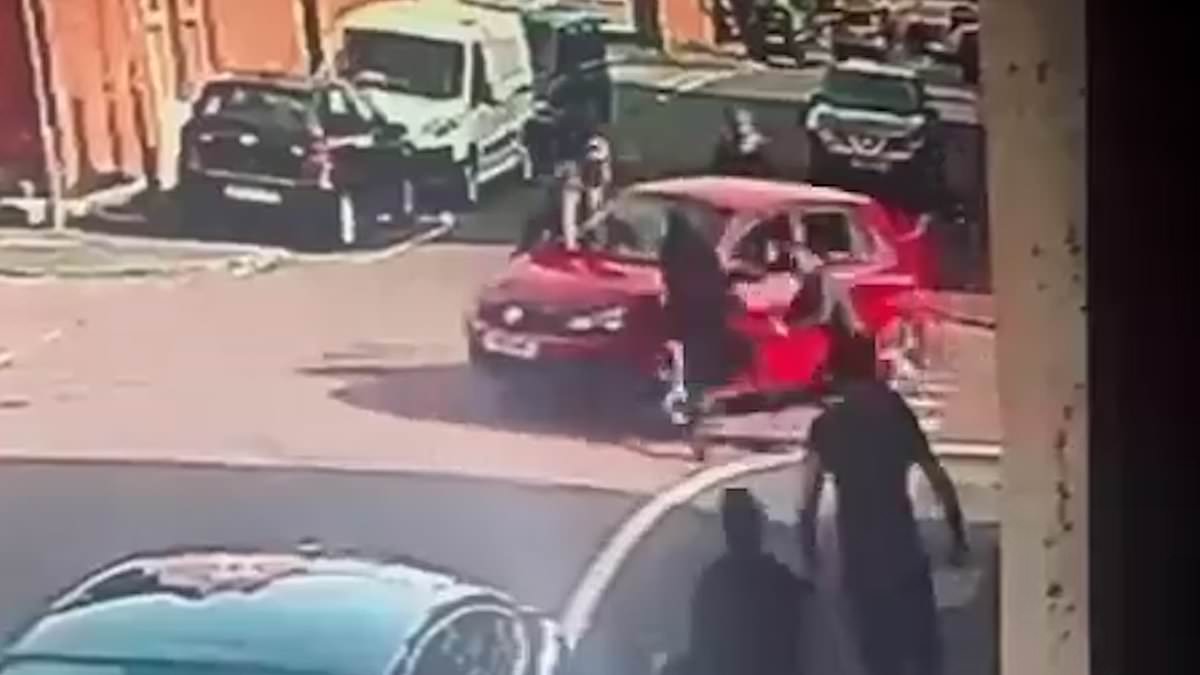 WorkersPartyGB's tweet card. Dramatic footage filmed on Thursday afternoon shows a red car accelerating into the group on a quiet residential street in Ashton-under-Lyne, Greater Manchester before fleeing the scene.