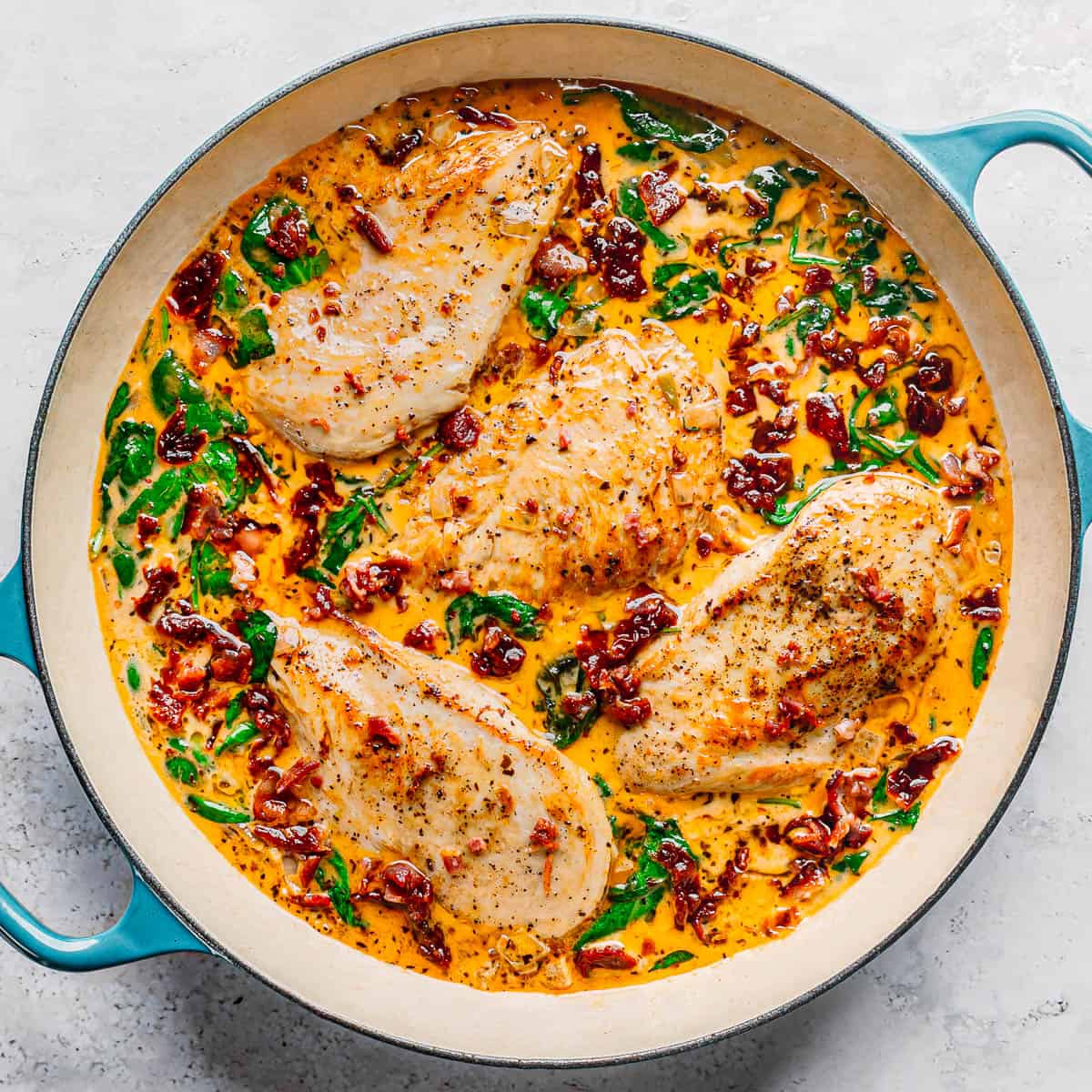 PoshJournalBlog's tweet card. Delicious creamy chicken with sun-dried tomatoes and spinach, perfect for a flavorful and comforting meal.