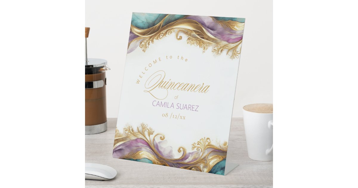 ArrayStores's tweet card. This elegant 'Welcome' pedestal sign is perfect for a quinceanera celebration in shades of gold, teal, and lavender. The beautiful design features ornate gold and shimmering accents, setting the tone...
