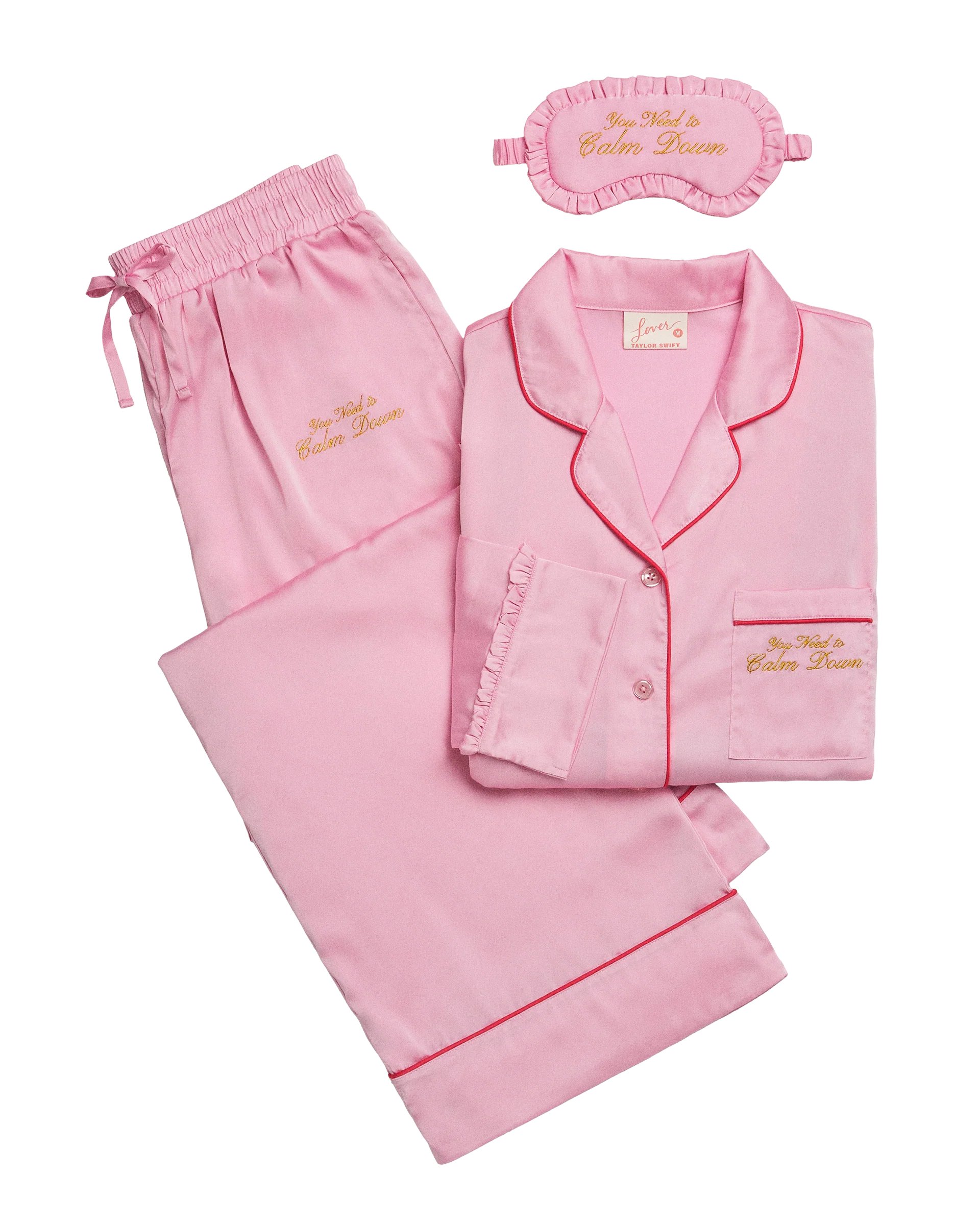 swiftpitch_uk's tweet card. Ships within 10 daysPink satin long sleeve button up top and drawstring pants with pockets featuring hot pink contrast stitching and "You need to calm down" song lyrics in gold lurex embroidery on...