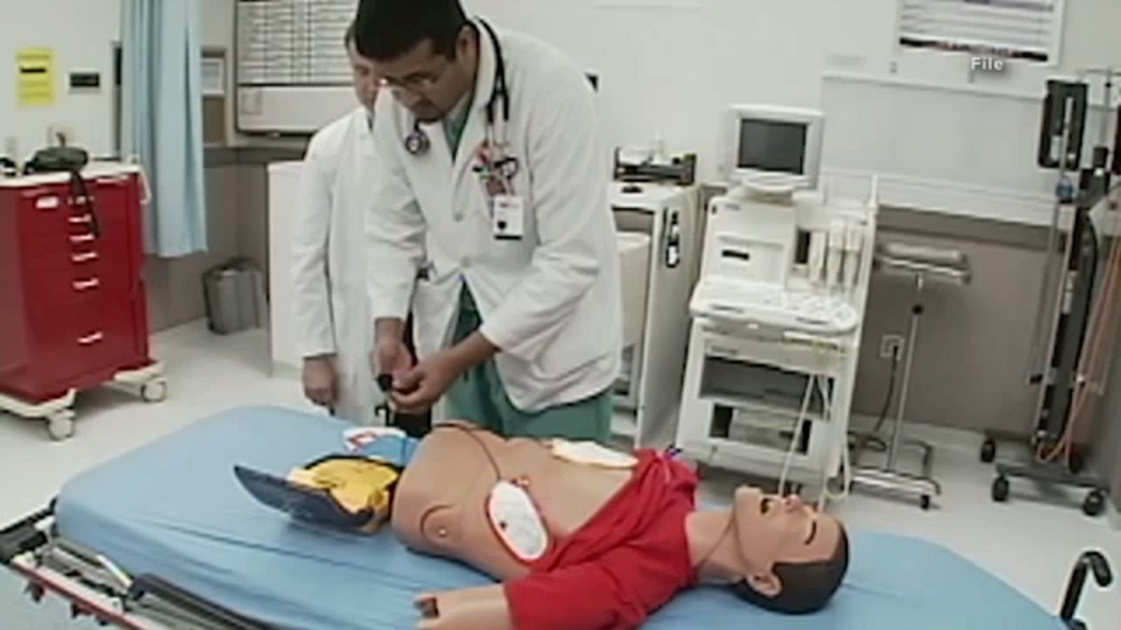 doc_vijay's tweet card. An AED is used to help restore a person's heartbeat when it stops. The teachers' union claimed a faculty member tried to use the machine on a dying student, but it failed to function.