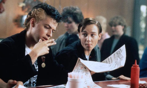 BoxReview_'s tweet card. Hiding Out is a 1980s thriller-comedy where a stockbroker on the run hides out as a high school student, rediscovering youth while evading danger at every corner.