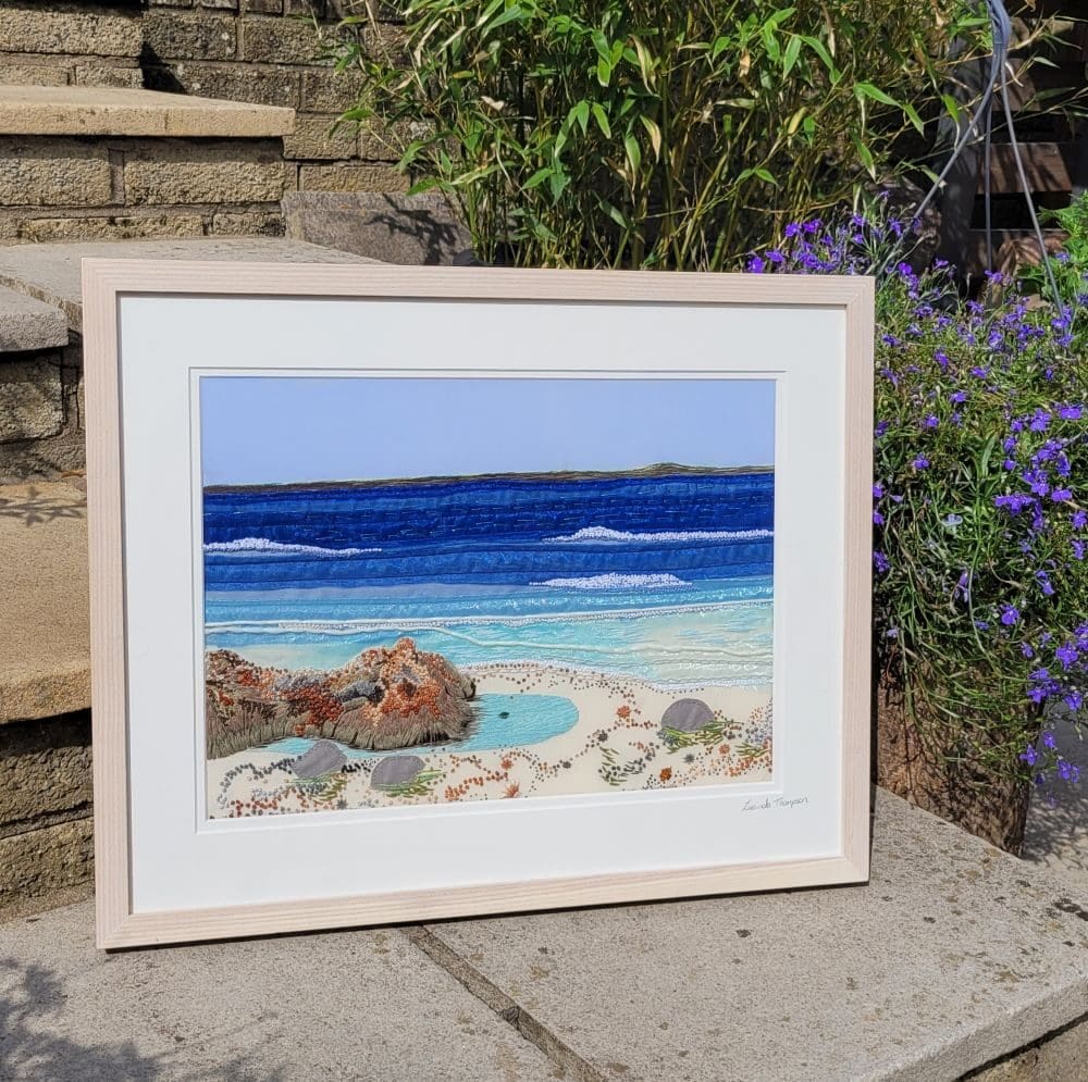ScrollOnDesign's tweet card. Large hand embroidered framed wall art of a rockpool, shells and pebbles. I have used lots of tiny french knot stitches and woven wheel stitch to create the texture of the rock and all the pebbles...