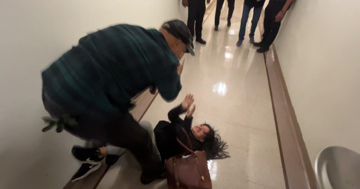 CBSNews's tweet card. An ICE officer who was captured on video pushing a woman to the ground outside an immigration court in New York City has been relieved of his duties.