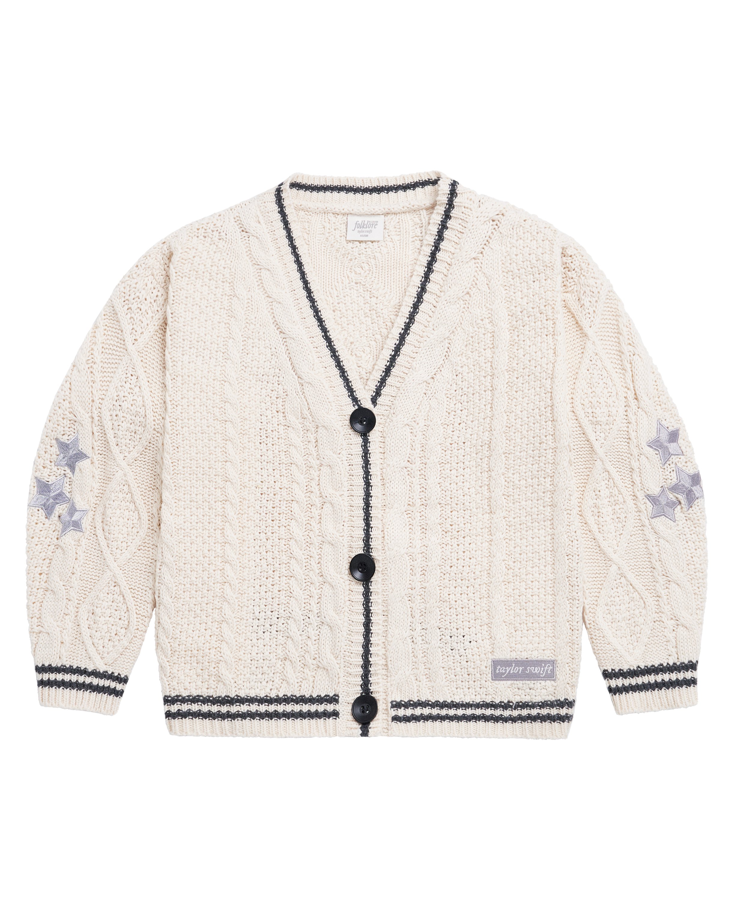swiftpitch_py's tweet card. Cream three button cable knit cardigan with black matte buttons, dark gray trim, 3 light gray star embroidery on both arms, and light gray "taylor swift" patch on bottom left with white font. Acrylic...