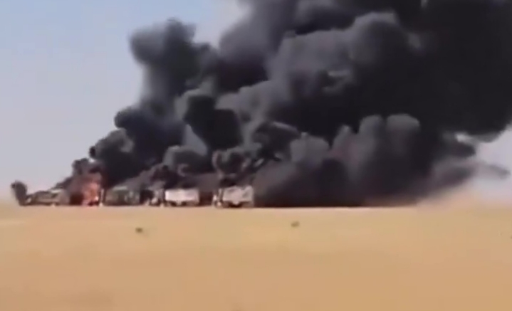 PatrickHeinisc1's tweet card. From one angle, the four trucks burning in the desert of western Sudan are barely noticeable. Black smoke from the smoldering munitions tucked inside their canvas-covered rear beds billows upward to...