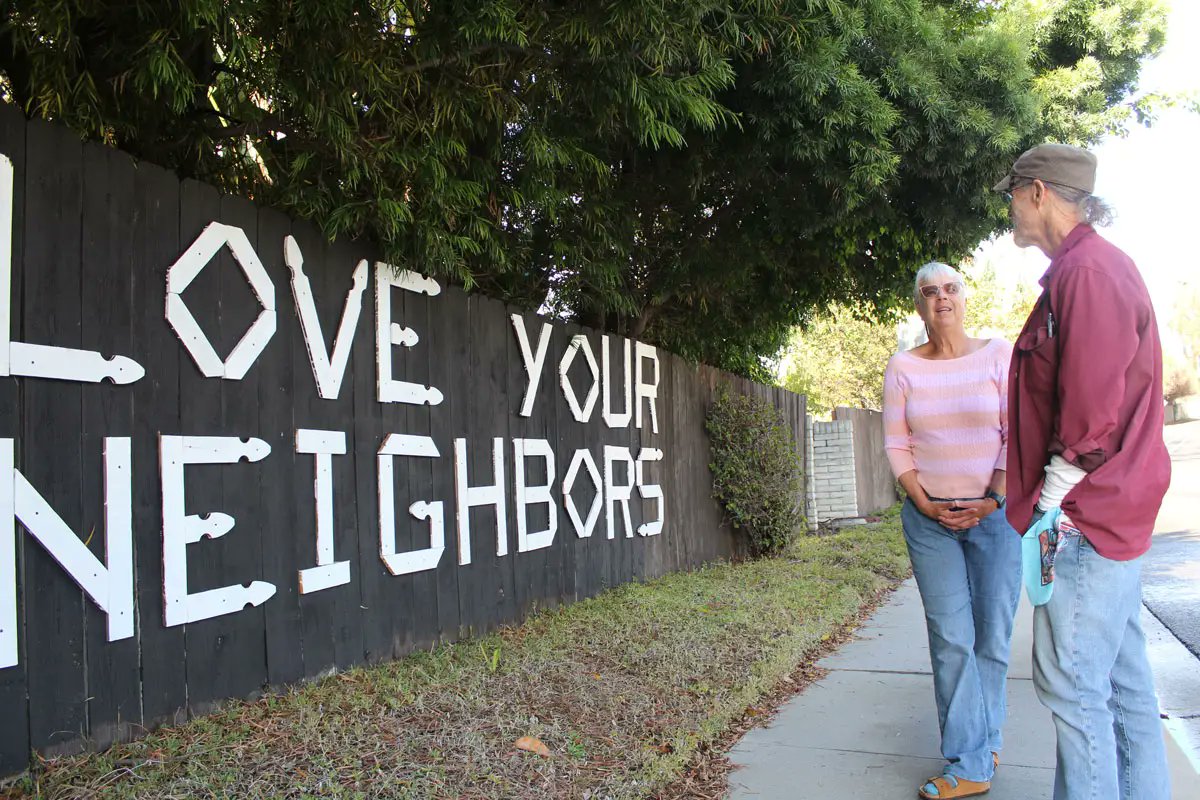 tonyperrysd's tweet card. An Encinitas homeowner who installed “Love Your Neighbors” on his wooden backyard fence has been ordered by the city to remove the display.