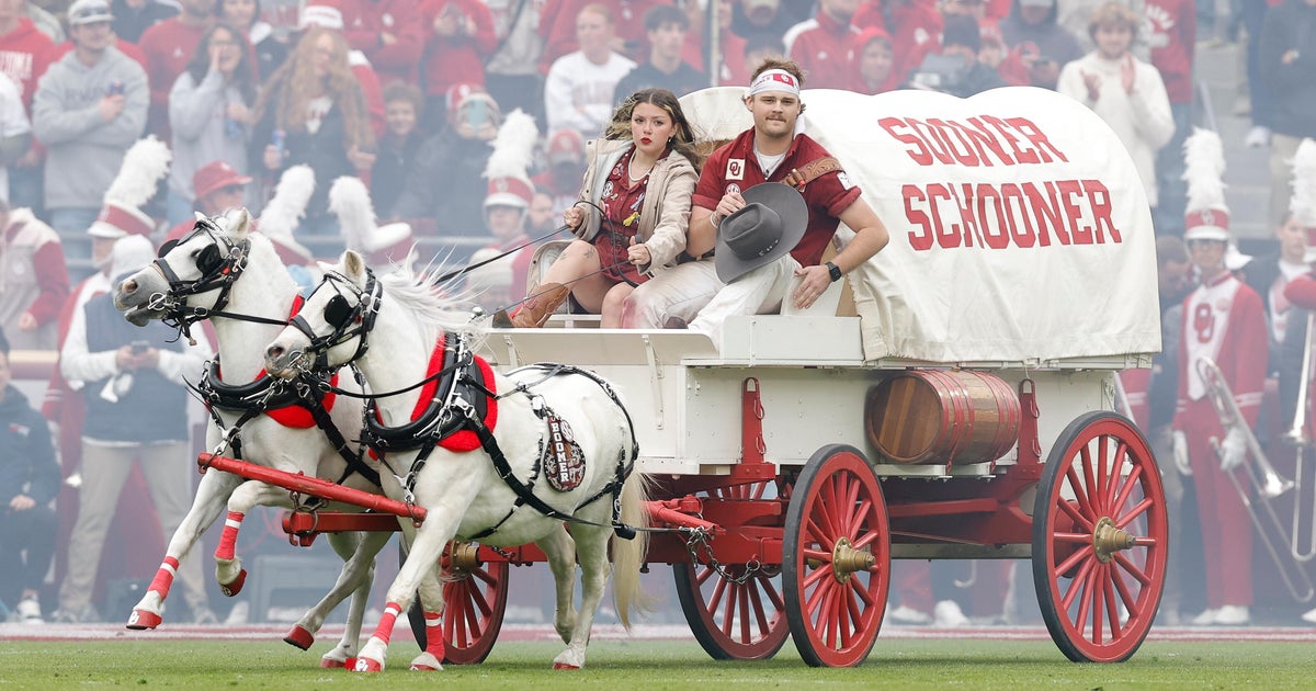 CBSNews's tweet card. First introduced in 1964, the Sooner Schooner is pulled across the field before the game and after Oklahoma scores by matching white ponies named "Boomer" and "Sooner."