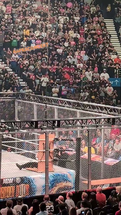 UndertakeAAP's tweet card. Will Ospreay pushes Jon Moxley into the Barbed Wire table The O2