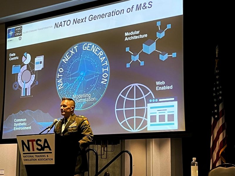 danwilli's tweet card. MODSIM World 2023 is underway! Stephen N. presenting how Data-centric, Modular open architecture and Web-enabled represent the core values and philosophy at the heart of a common synthetic environm...