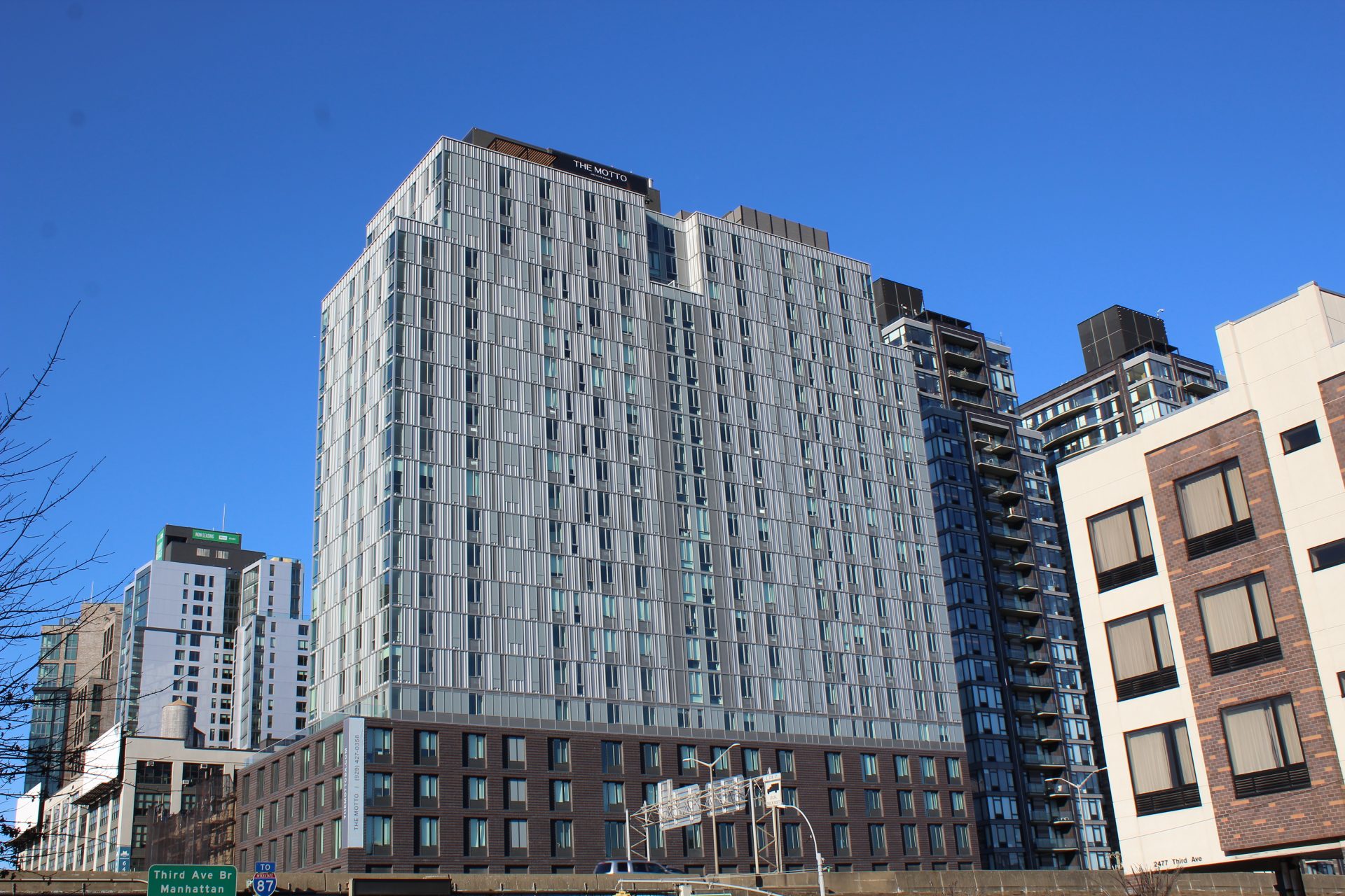 trinamdesign's tweet card. The Motto Apartments is a new 24-story complex featuring a façade of contemporary silver metal and large glass panels.