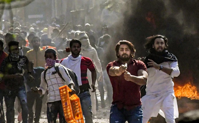 UnSubtleDesi's tweet card. Shahrukh Pathan, who pointed a gun at a policeman during the anti-Hindu riots in North-East Delhi in 2020, was refused regular bail by a Delhi court on 14th December. | OpIndia News