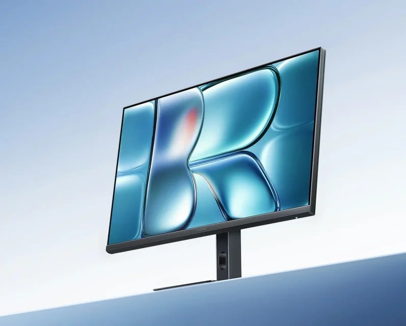 TudoCelular's tweet card. O dispositivo mantém o painel IPS de 27 polegadas com resolução de 2560 × 1440, mas traz melhorias em taxa de atualização, precisão de cores e conforto visual.