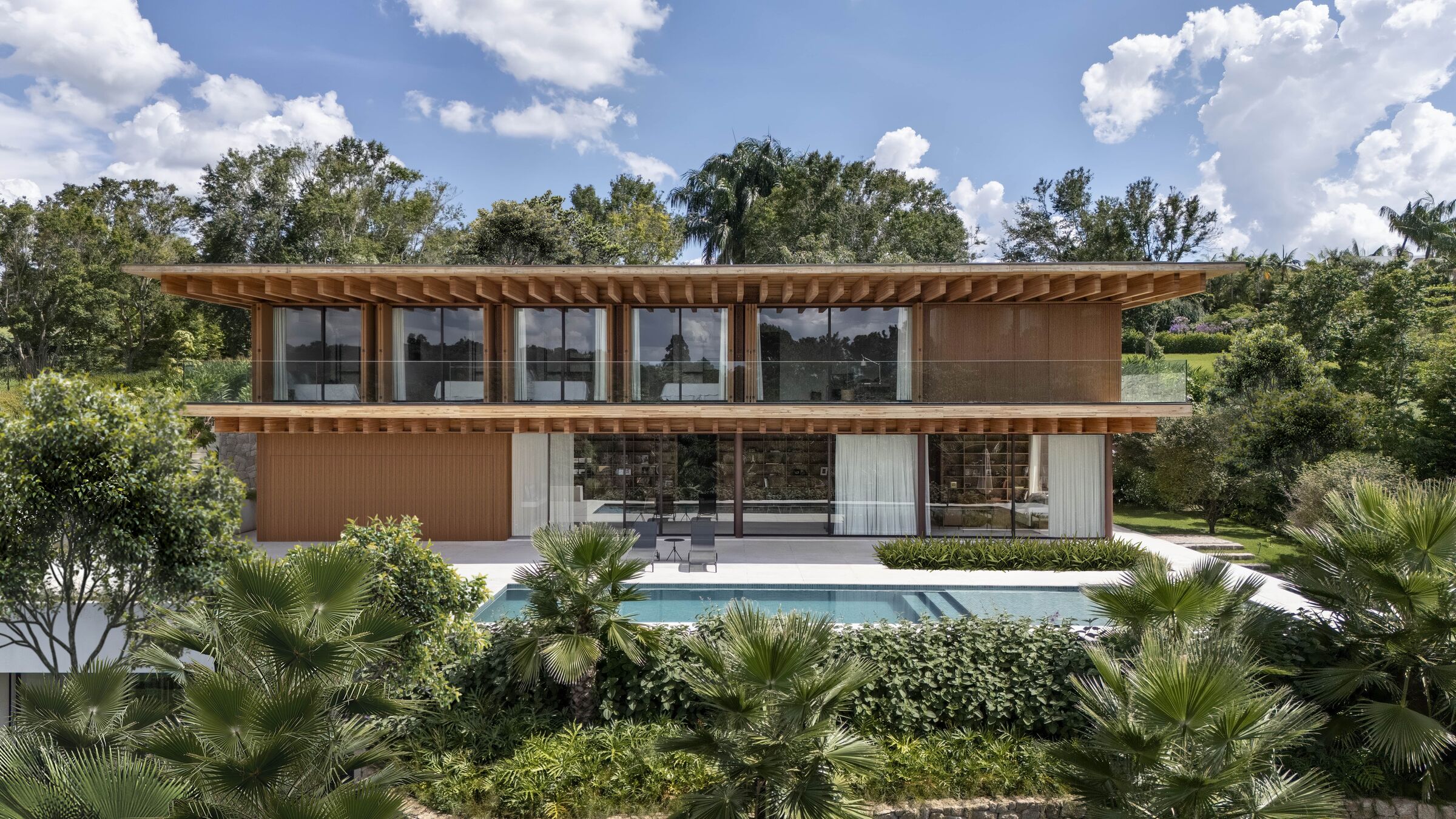 Official_anwo's tweet card. A three-level home that honors the natural slope beautifully. #designsmart #homegoals